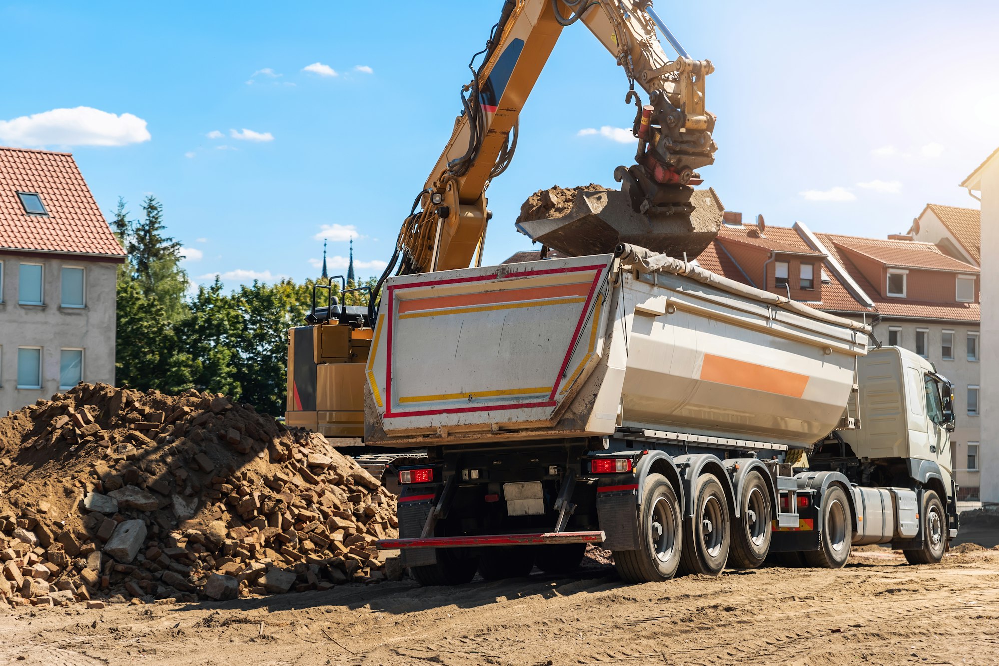 Heavy excavator machine debris rubble truck construction site. Building waste disposal service.